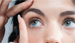 close up of woman inserting contact lens